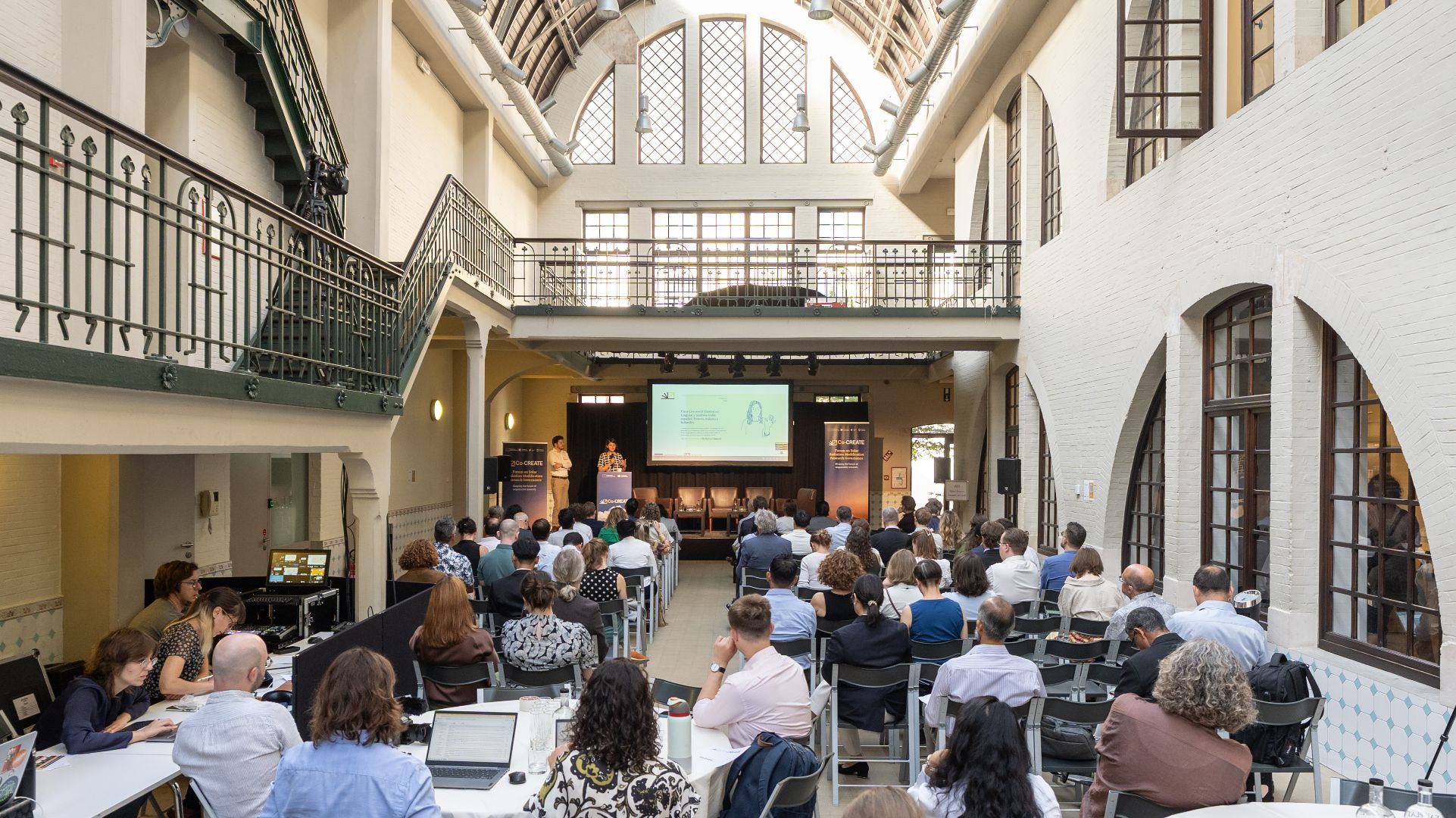 An audience facing the stage at the Co-CREATE Forum on Solar Radiation Modification Research Governance